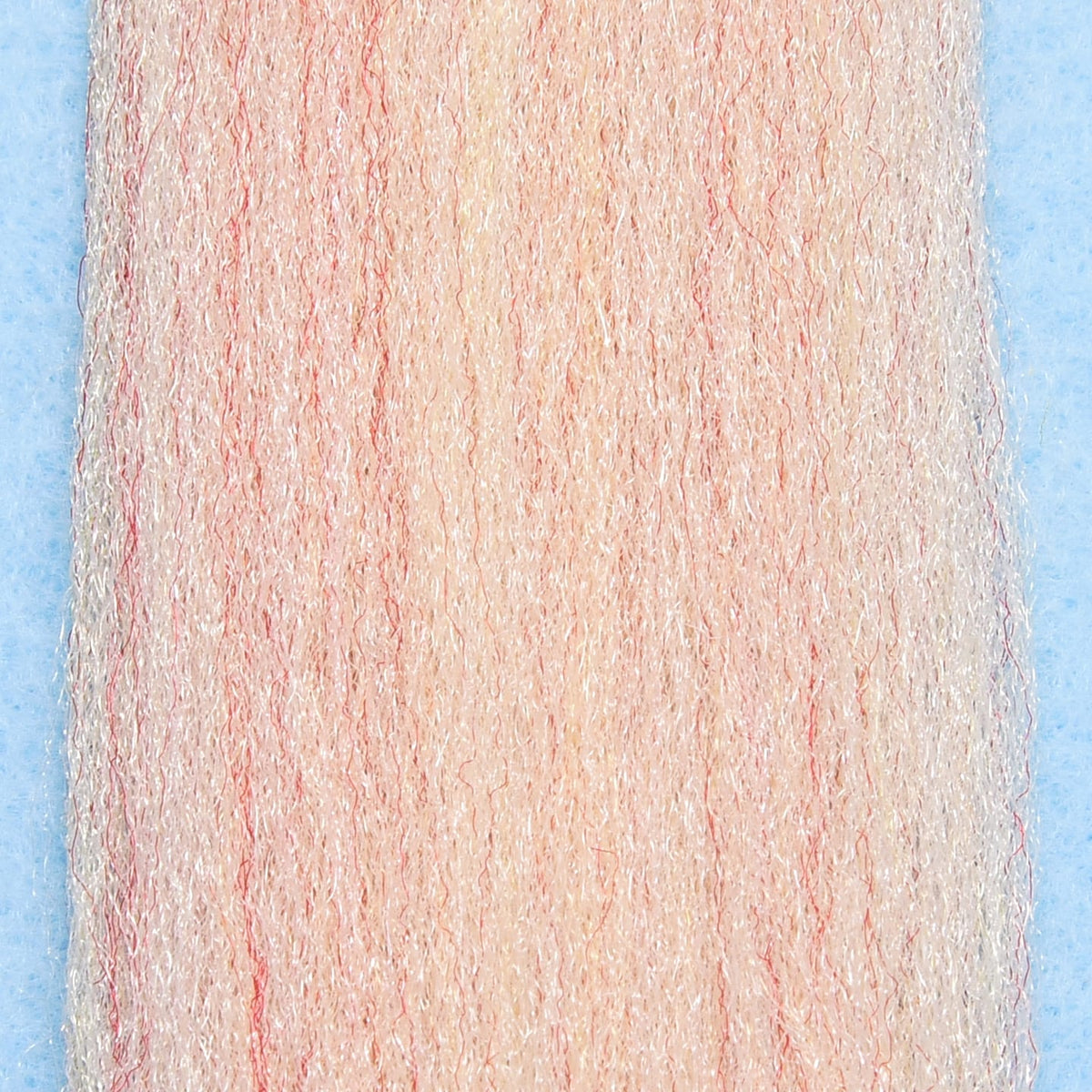 Close-up of light pink and white synthetic fibers with subtle red strands, designed for fishing lure crafting, identified as EP Trigger Point Fibers.