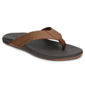Simms Panga Flip Flops in brown and black with a comfortable cushioned footbed, durable woven straps, and a small fish emblem on the upper strap, designed for casual outdoor wear.
