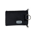 Chums Surfshorts Wallet in black with a textured fabric exterior, dual zipper compartments, and a metal key ring for secure storage and easy access.