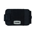 Chums Bandit Bi-Fold Wallet in black with textured exterior and elastic band closure featuring a white logo patch, designed for secure and compact storage.