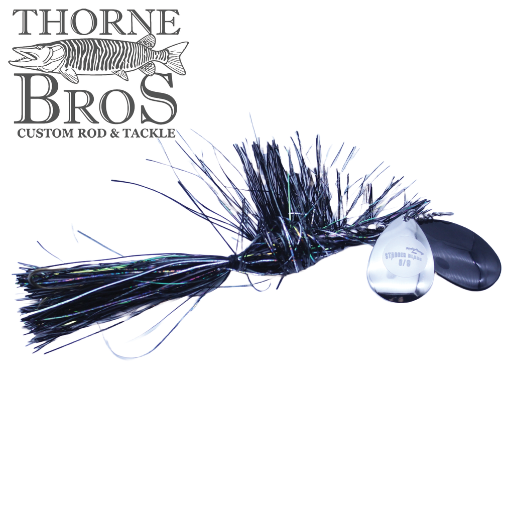 Black and iridescent fishing lure with a silver spinner blade, designed for musky fishing, identified as Musky Frenzy Apache Stag 8/9, shown on a white background.