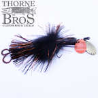 Pandemonium Tackle Marvin 88 fishing lure in black and orange with a fluffy feather body, metallic spinner blades, and dual hooks, designed for musky fishing.