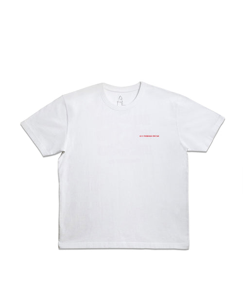 White t-shirt with red embroidered text "ça a toujours été toi" and a small black line-art candle logo near the collar.
