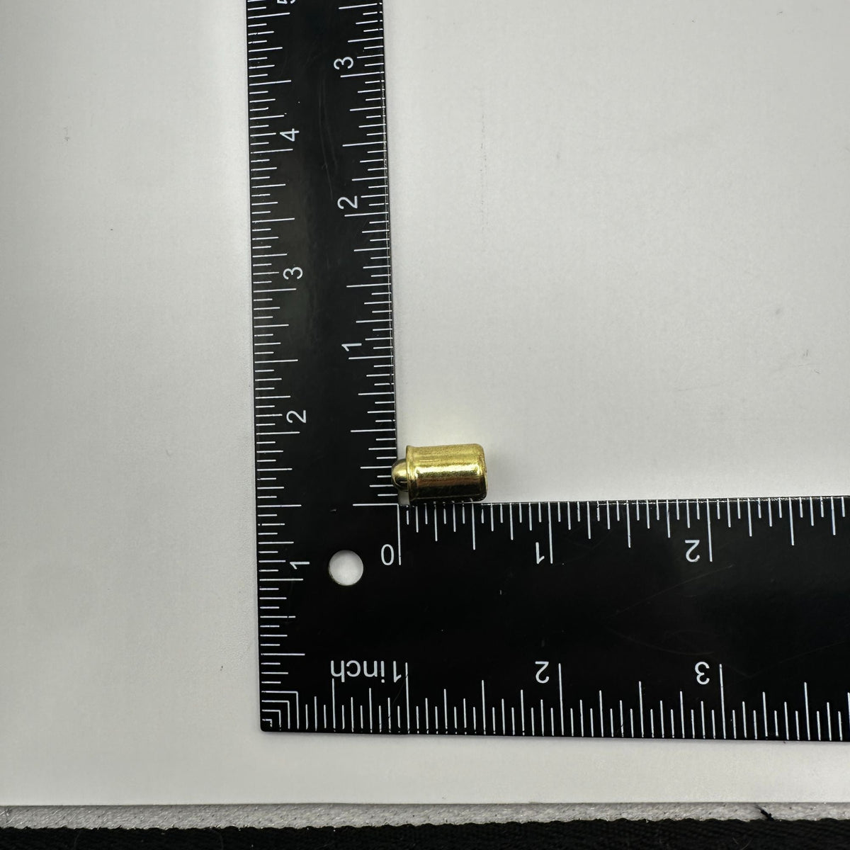 Two brass-plated steel bullet catches for cabinet doors with a cylindrical shape and a flat base for mounting. showing size large 