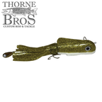 Gold glitter fishing lure with white underbelly and realistic eye detail, featuring multiple hooks and flexible tail, designed as the Boss Shad Medium Hybrid for musky fishing.