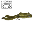 Boss Shad Small Hybrid fishing lure with a segmented, glittery gold body, lifelike eyes, and soft tail designed for effective musky fishing.