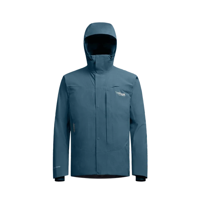 Sitka CAT-5 Jacket in blue designed for outdoor fishing activities, featuring a hood, full front zipper with storm flap, and breathable waterproof fabric for protection against harsh weather.