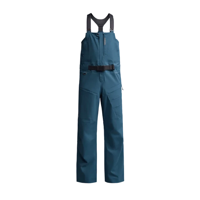 Sitka CAT-5 Bib in deep teal color, waterproof fishing bib pants with adjustable shoulder straps and a black waist belt designed for comfort and protection during fishing activities.