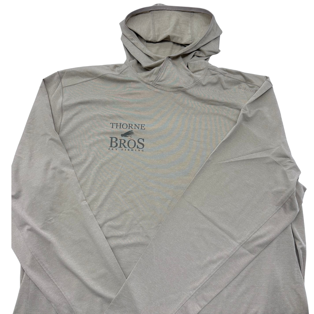Light gray Simms Thorne Bros. Fly Fishing Logo SolarFlex Hoody with long sleeves, a hood, and printed logo on the front, designed for sun protection during fishing activities.