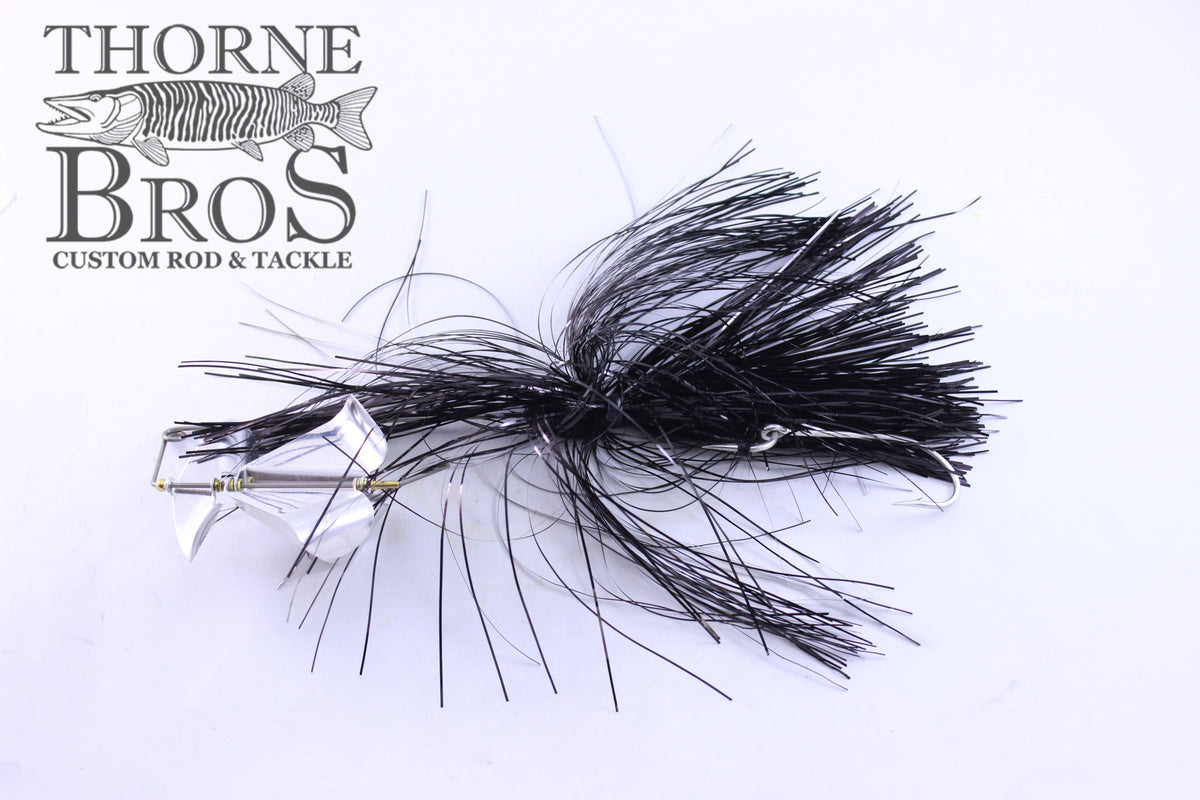 Ruff Tackle Rad Dog Tinsel Buzz fishing lure with black tinsel skirt and silver spinner blades, designed for musky fishing, displayed on white background with Thorne Bros logo.