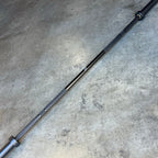 Blue 20kg Hybrid Bar shown diagonally on a concrete floor, alternate angle