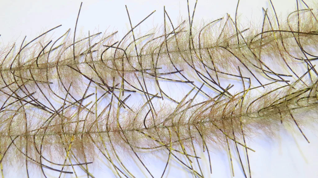 Close-up image of the Lively Legs Crustacean Brush showing detailed, fine, hair-like fibers in natural brown and gold tones designed to mimic crustacean movement for fishing tackle.
