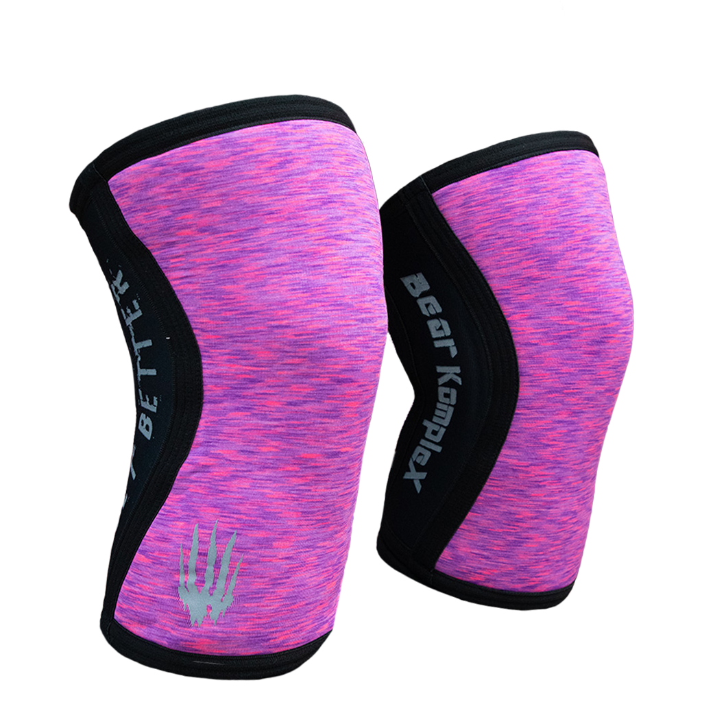 Pair of pink and black knee sleeves with 'Bear Komplex' branding on a white background