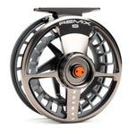 Close-up of a sleek, metallic grey Lamson Remix S fly fishing reel featuring a ventilated spool design and orange accent on the drag knob, ideal for precision casting.