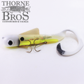 Musky Innovations Bull Dawg Magnum - Standard Harness fishing lure in translucent yellow and white with dual treble hooks and a curled tail designed for musky fishing.
