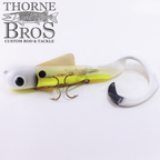 Musky Innovations Bull Dawg Magnum - Standard Harness fishing lure in translucent yellow and white with dual treble hooks and a curled tail designed for musky fishing.