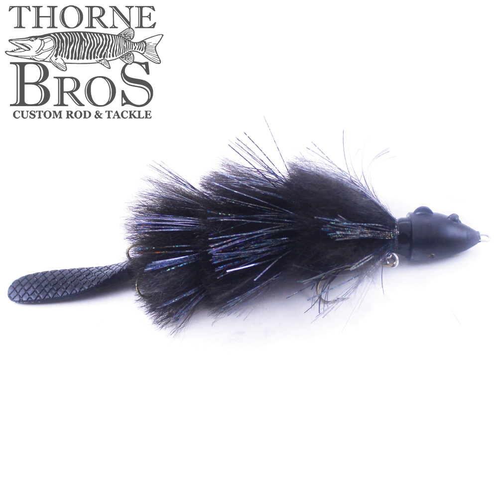 Baby Beaver Mini Beaver fishing lure in black with feathered body, shiny accents, textured tail, and a small weighted head designed for musky fishing.