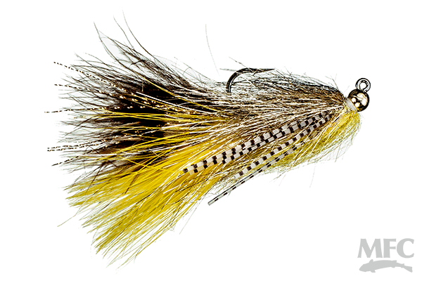 Jig Sparkle Yummy fishing lure with layered brown and yellow feathers and a sharp metal hook designed for musky and fly fishing tackle.