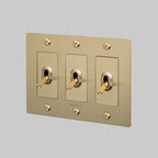 Buster + Punch NTK-054392 Linear 3-Gang Toggle Switch With Logo, 15A, Single Pole/3-Way, Brass