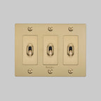 Buster + Punch NTK-054392 Linear 3-Gang Toggle Switch With Logo, 15A, Single Pole/3-Way, Brass