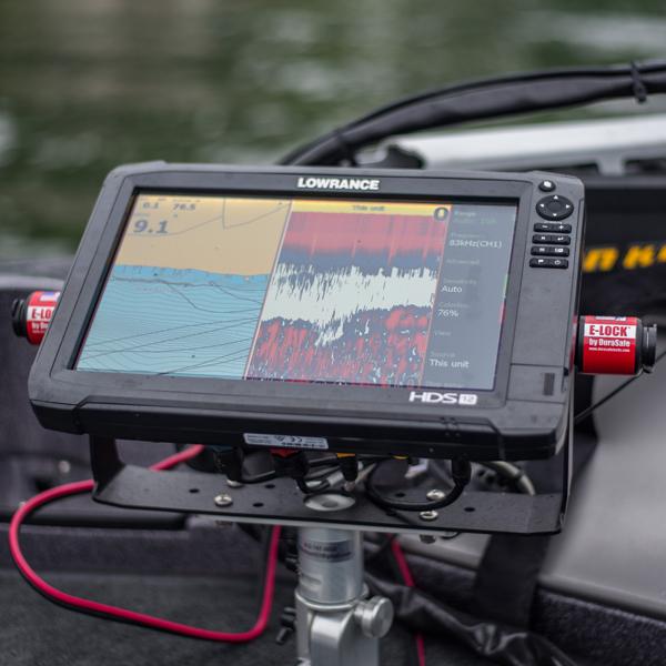 Lowrance marine electronics fish finder mounted on a boat with a DuraSafe E-Lock Max red locking device attached to the side for secure fishing tackle and rods.