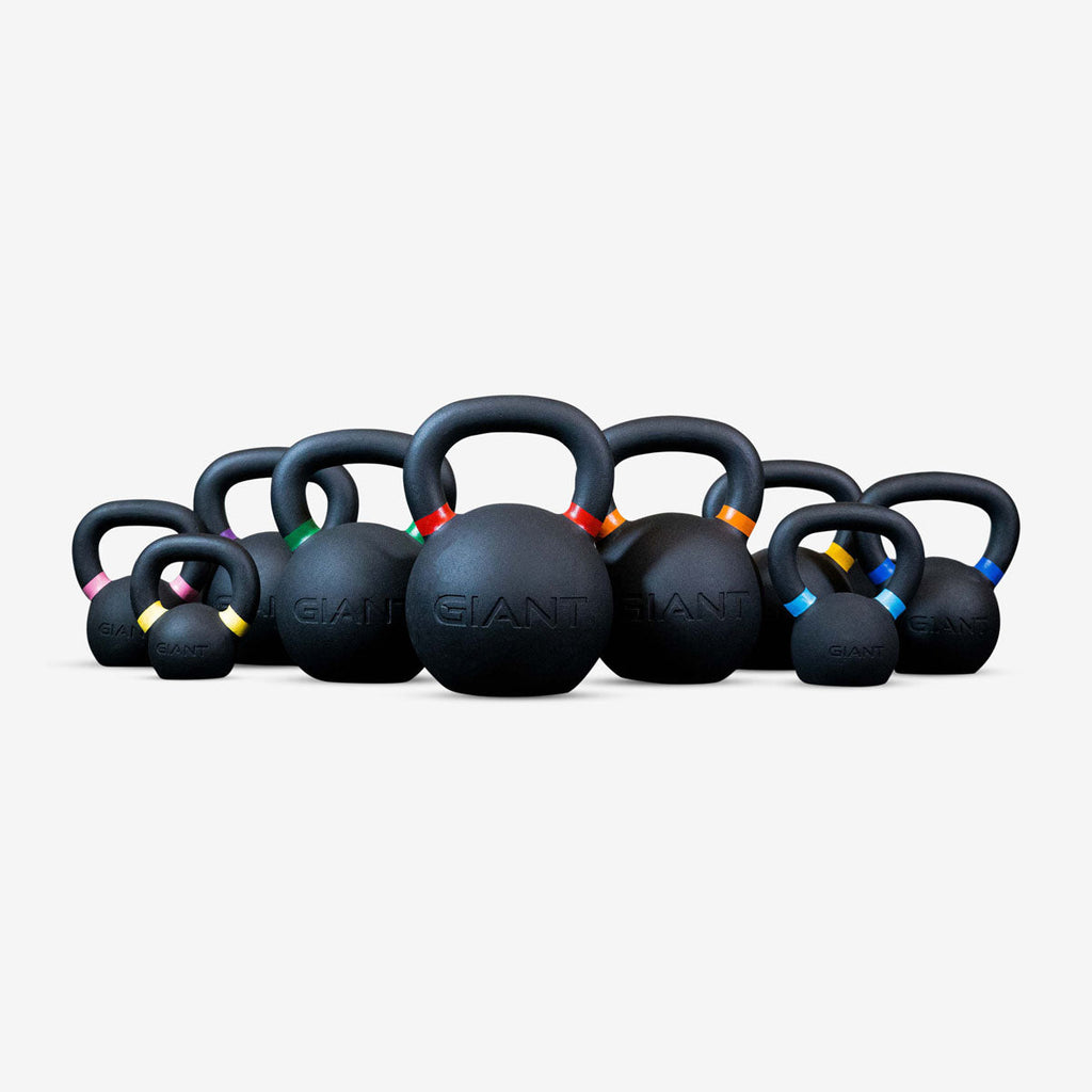 Lineup of Giant Lifting kettlebells in various sizes with colored handle bands, on a white background